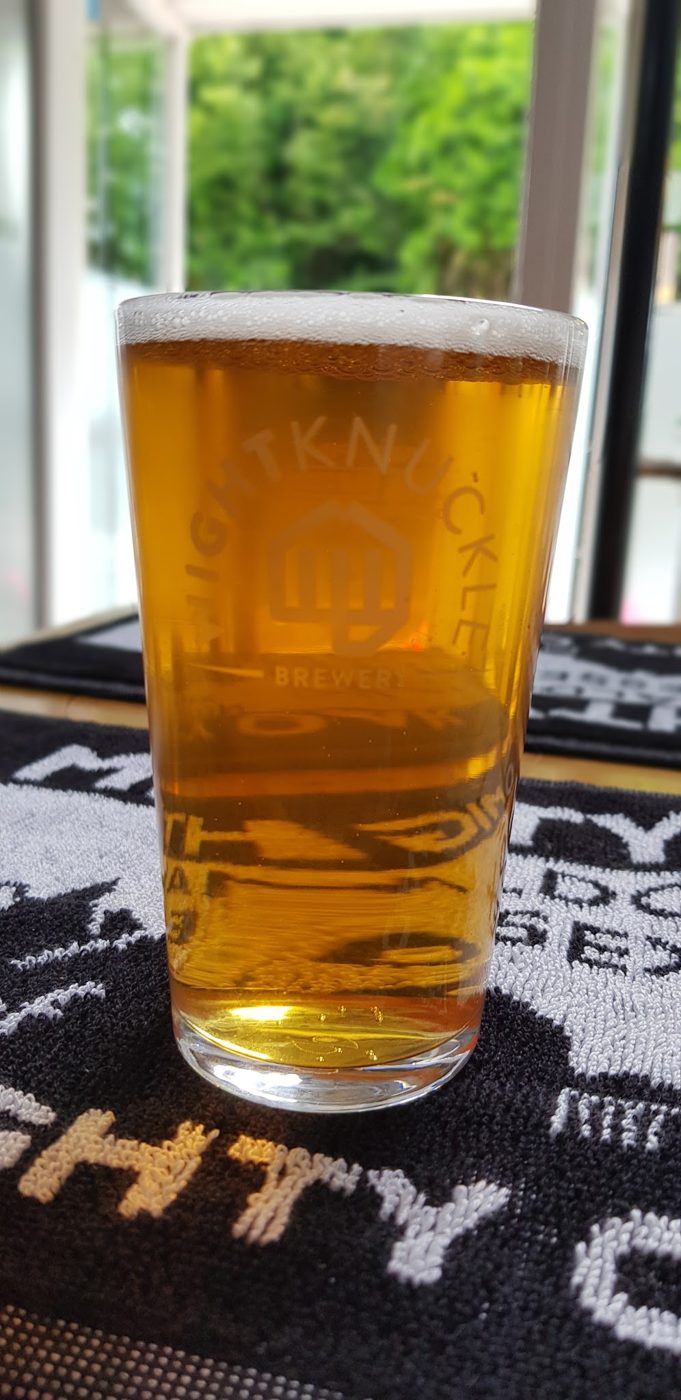 A golden pint on a bar towel